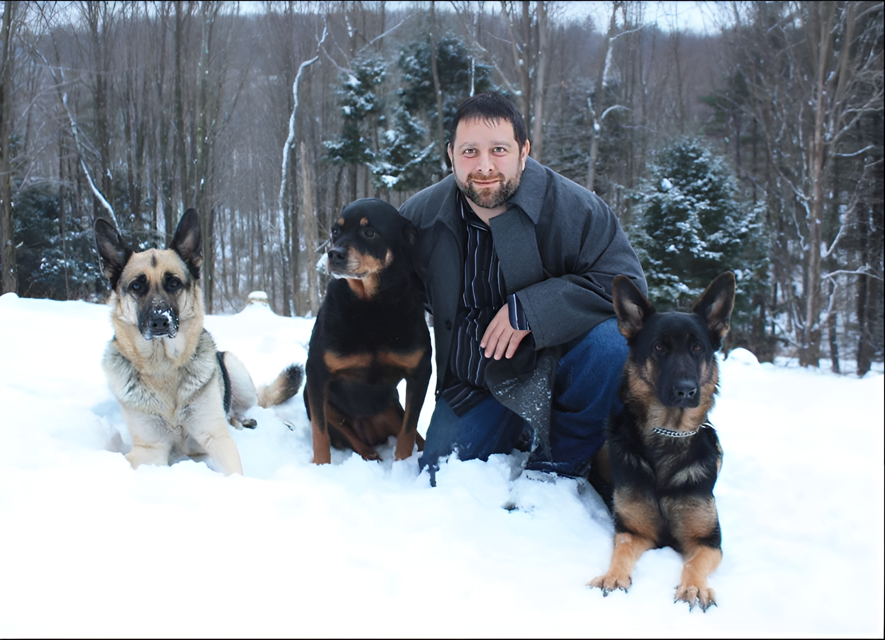 Tony poses with his family pets in the snow.